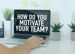 "How do you motivate your team?" white text on the laptop black screen