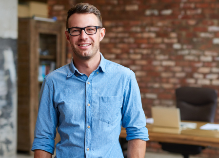 A man is looking confidence smiling at the camera